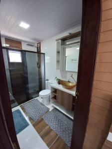 a bathroom with a shower and a toilet and a sink at La Casa de Gramado in Gramado +15 photos