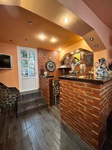 a bar in a room with a brick wall at Pensiunea Lorena in Bran