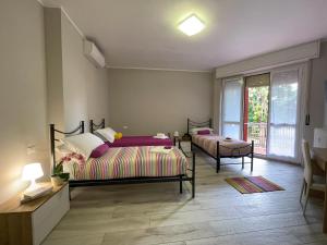 a bedroom with two beds and a window at Bnbook Lattuada 3 camere da letto 2 bagni in Rho
