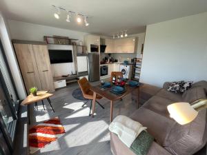 a living room with a couch and a table at Panoramic apartment in Varna with underground parking in Varna City