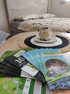 a table with a magazine and a cake on it at Apartman Andjela in Pluzine