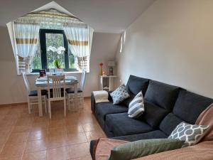 a living room with a couch and a table at Ático de Carmen in Cee