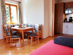 a living room with a dining room table and chairs at Bauernhof Pension Juri in Obergösel