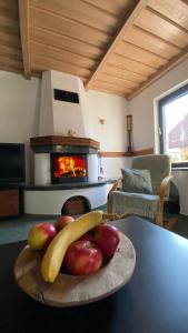 a bowl of fruit on a table with a fireplace at Apartma Nomad in Novo Mesto
