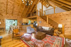 a living room with a staircase in a log cabin at New Listing! Lakeview Lodge - 5 Bed, 4 Bath - Hot Tub in Dahlonega