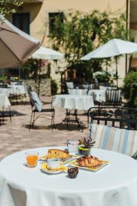 einen Tisch mit einem Teller Essen drauf. in der Unterkunft Hotel Locanda Ruscello Garnì in Limone sul Garda