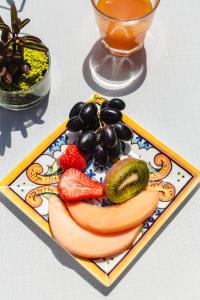 a plate of fruit and vegetables on a table at Hotel Locanda Ruscello Garnì in Limone sul Garda
