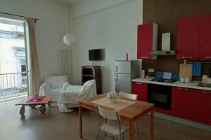 un soggiorno con tavolo e cucina di Appartamento - Casa Madre a Napoli
