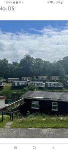 a picture of a house with houses in the background at Sunny49 in Caeathro