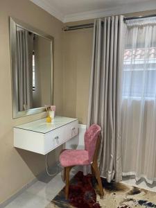 a bathroom with a vanity with a mirror and a chair at Side Step in Johannesburg