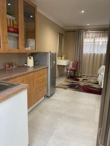 a kitchen with a refrigerator and a table in it at Side Step in Johannesburg