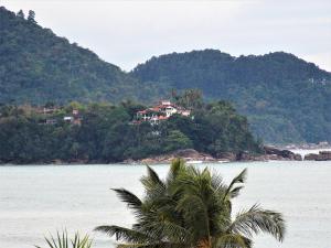 a house on an island in the middle of the water at Paraiso do Sol in Ubatuba