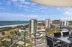 a balcony with a view of a city and the ocean at Aqua Vista Resort in Maroochydore