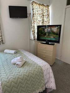 a bedroom with a bed and a flat screen tv at Northern Pearl Hotel in Blackpool
