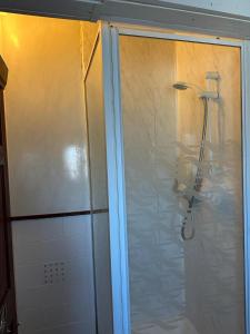 a shower in a bathroom with a glass door at Northern Pearl Hotel in Blackpool