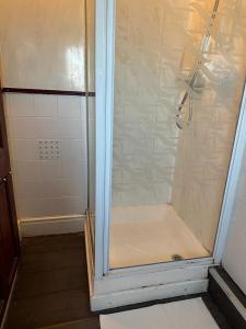 a shower with a glass door in a bathroom at Northern Pearl Hotel in Blackpool