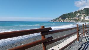 a wooden fence on a beach near the ocean at ANFORA HOUSE in Genoa