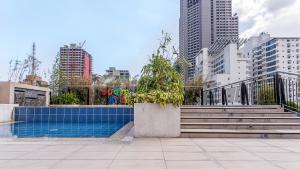 a swimming pool in a city with tall buildings at Y2 Residence Hotel Managed by HII in Manila