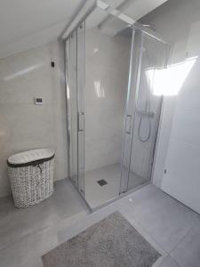 a shower with a glass door in a bathroom at Apartment Loft in Sinj