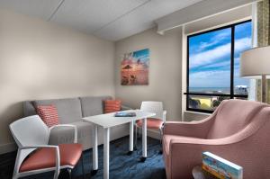 a waiting room with a table and chairs and a window at Surfside Beach Oceanfront Hotel in Myrtle Beach