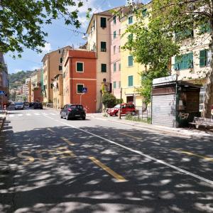 an empty city street with a car parked on the street at ANFORA HOUSE in Genoa
