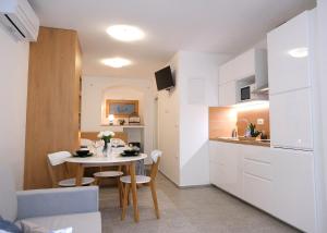 cocina pequeña y comedor con mesa y sillas en Apartma Libris, en Koper