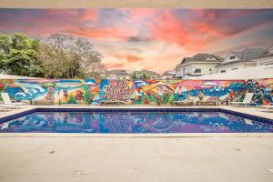 a mural on the side of a building with a swimming pool at Americas Townhouse Hotel in Rio de Janeiro