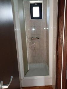 a bathroom with a shower with a glass door at Le repaire des renards Vallée de Rabais in Virton