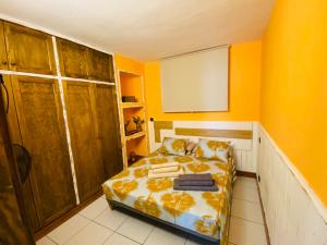 a small bedroom with a bed and yellow walls at CASA ATLANTICO in Puerto del Carmen +3 photos