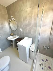 a bathroom with a toilet and a sink and a shower at Appartement FUN & SUN in San Isidro +45 photos