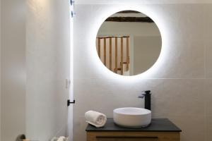 a bathroom with a white sink and a mirror at Casa Rural Lavadero en Teresa in Ríos de Abajo +32 photos