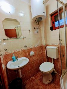 a bathroom with a toilet and a sink at Apartments Normannia in Dobra Voda