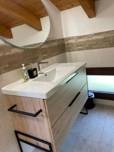a bathroom with a sink and a mirror at B&B Del Corso in SantʼAgata Bolognese