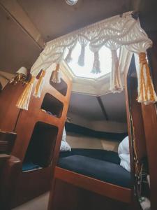 a small bed with a canopy in a room at Lady Blue Yacht in Nida in Nida