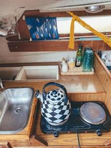 a kitchen counter with a sink and a tea kettle at Lady Blue Yacht in Nida in Nida