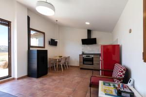 a kitchen with a red refrigerator and a table at Casa Rural Lavadero en Teresa 
