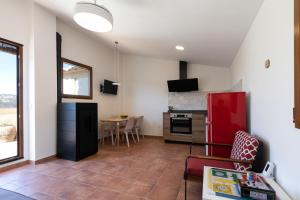 a kitchen with a red refrigerator and a table at Casa Rural Lavadero en Teresa in Ríos de Abajo