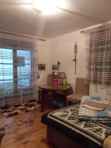 Zimmer mit einem Bett, einem Tisch und einem Fenster in der Unterkunft Rooms Apartment Durmitor in Žabljak