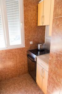 a small kitchen with a stove and a window at Apartment Filip in Bar