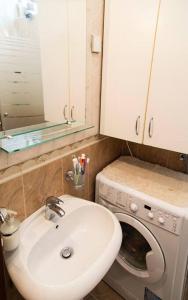 łazienka z umywalką i pralką w obiekcie Apartment Filip w Barze