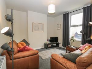 a living room with two couches and a window at North Harbour House in Weymouth