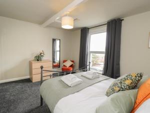 a bedroom with a bed and a large window at North Harbour House in Weymouth