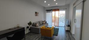a living room with a couch and a yellow chair at Zinas modern flat Nicosia in Strovolos