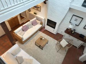 a living room with a couch and a fireplace at Maison bord de mer 10 couchages in Saint-Vaast-la-Hougue