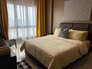 a bedroom with a large bed and a window at Alpha LaVista at Emira Residence Shah Alam in Shah Alam