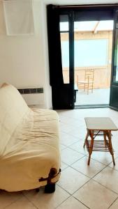 a bed and a coffee table in a room at Studio au cœur de Laguiole in Laguiole +4 photos