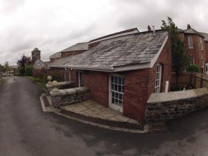 a brick house with a roof on a street at Cosy 2 bed cottage on Dartmoor , Near Ivybridge in Plymouth