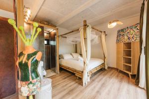 a bedroom with a bed and a vase in a room at Maxia Galega -Arte, Natureza, Relax -Ribeira Sacra in Monforte de Lemos +27 photos
