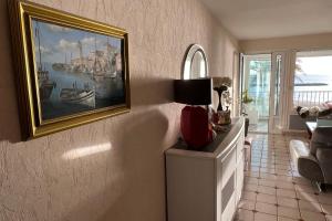 a living room with a painting on the wall at Appartement Mar e Souleu avec Terrasse et Vue Mer au Grau du Roi in Le Grau-du-Roi +32 photos