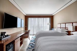 Postel nebo postele na pokoji v ubytování Sheraton Santos Hotel